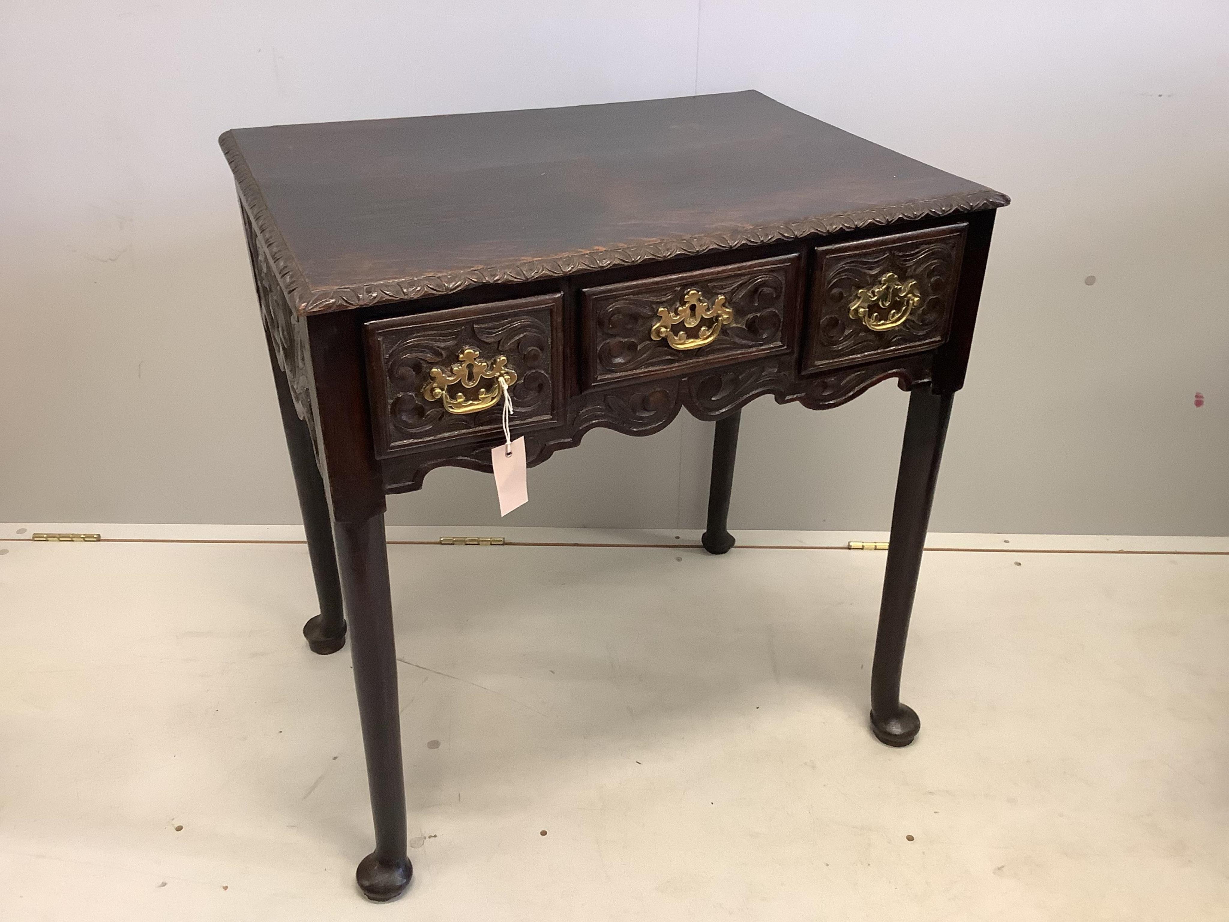 An 18th century oak lowboy, (later carved), width 70cm, depth 50cm, height 73cm. Condition - fair